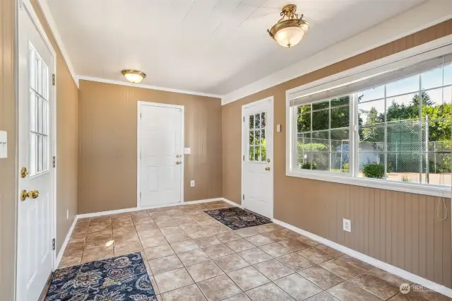 Whether you're coming in from the front of the house, the garage, or the backdoor, the breezeway serves as a transitional space that keeps your home clean and organized. The tiled floor allows easy cleaning and maintenance.
