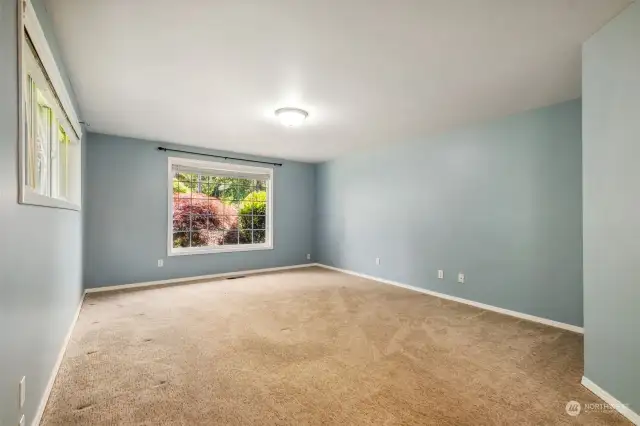 Large primary bedroom, 28’x13’, with walk-in closet, includes a large area (not shown in photo) which was used for office/study area. The strategic placement of the plantings in the front yard maintains a level of privacy by obscuring the view from the road while the window lets in ample light.