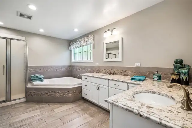 Primary bath updated in 2018 with its quartz counters, spacious shower, and luxurious Jacuzzi tub, the ensuite bathroom is a haven of comfort and indulgence, allowing you to pamper yourself and escape in style within the confines of your own private sanctuary.