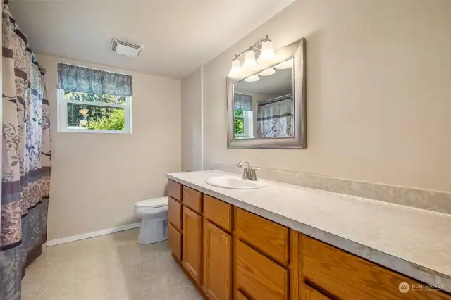Full-size bathroom upstairs with plenty of cabinet space.