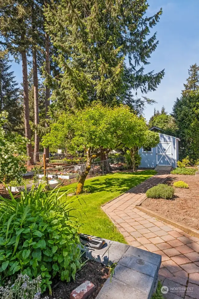 Nurture your green thumb in style with a meticulously landscaped garden area and fruit trees and a convenient shed for storing all your essential gardening tools and pots. This well-designed outdoor space combines both beauty and practicality.