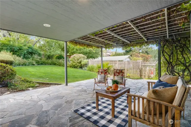 Covered stone patio exudes elegance and charm, offering a beautiful, sheltered outdoor space perfect for relaxing or entertaining in style.