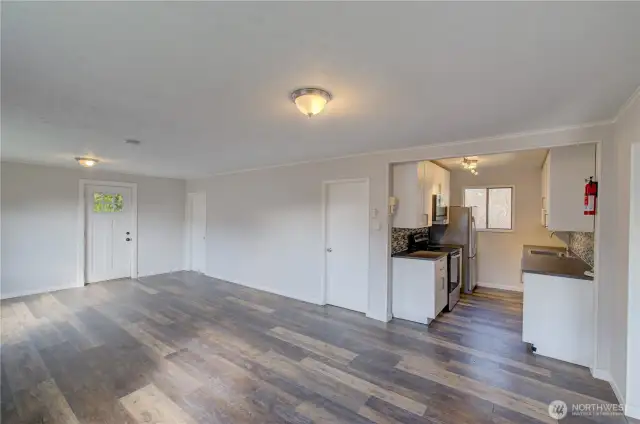 View of kitchen from end of living/dining room