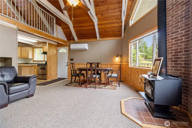 Great room with wood burning stove and tongue and groove cedar.