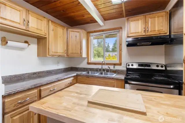Rolling island in the kitchen gives versatility.