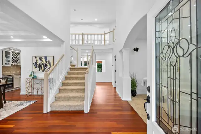 Through the leaded glass French doors, you are greeted with soaring 2-story ceilings, Brazilian cherry hardwoods, and an elegant double imperial staircase with a catwalk.