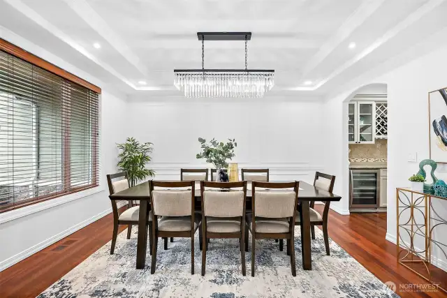 The formal dining area is very spacious with coffered ceilings with crown molding and recessed lighting.