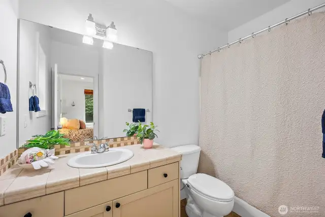 The main floor bedroom is located away from the living areas for privacy and has an en-suite bathroom.