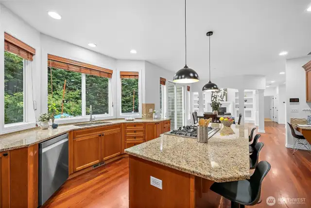 The kitchen features granite counters with ample prep space and stainless steel appliances.