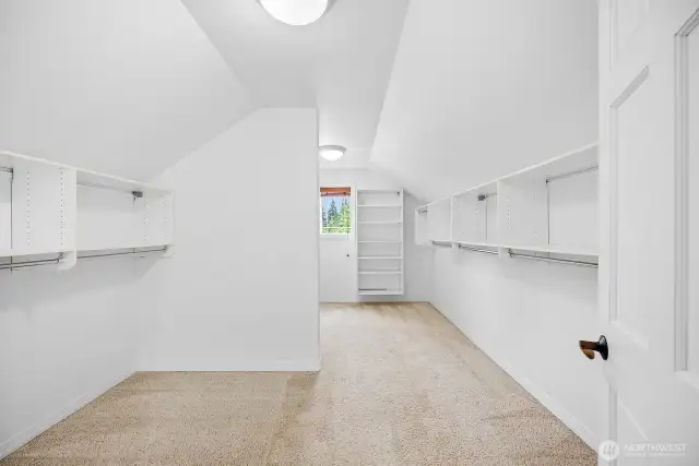 Huge walk in closet with shelving.