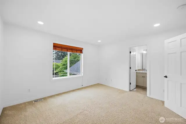 Bedroom 2 on the upper level features an en-suite bathroom.