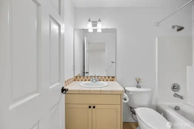 Bedroom 2 on the upper level features an en-suite bathroom.