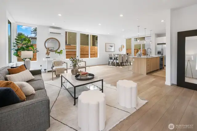 Step inside to a bright, open great room where living, dining, and kitchen spaces flow for effortless entertaining. Photos are of model home 8825, finishes and floorplan may vary.