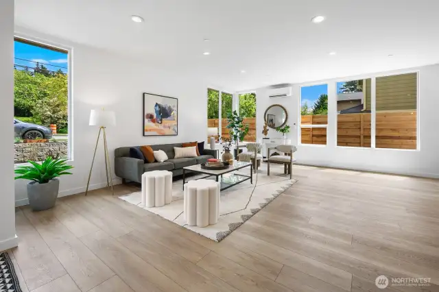Corner windows flood the main living space with natural light and connect you to the neighborhood. Photos are of model home 8825, finishes and floorplan may vary.