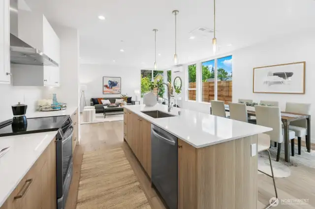 Dining zone sits between yard light and kitchen convenience—host with ease. Photos are of model home 8825, finishes and floorplan may vary.
