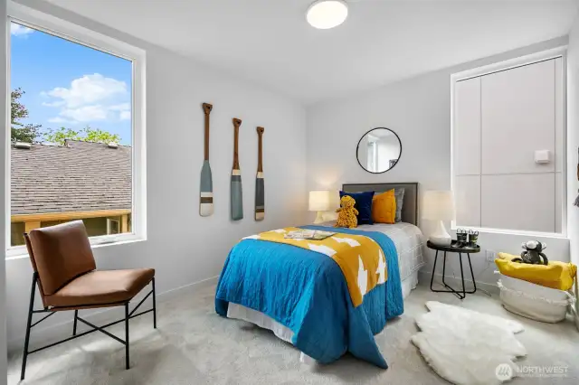 Playful bedroom styled with color and natural light—perfect for younger residents or guests. Photos are of model home 8825, finishes and floorplan may vary.