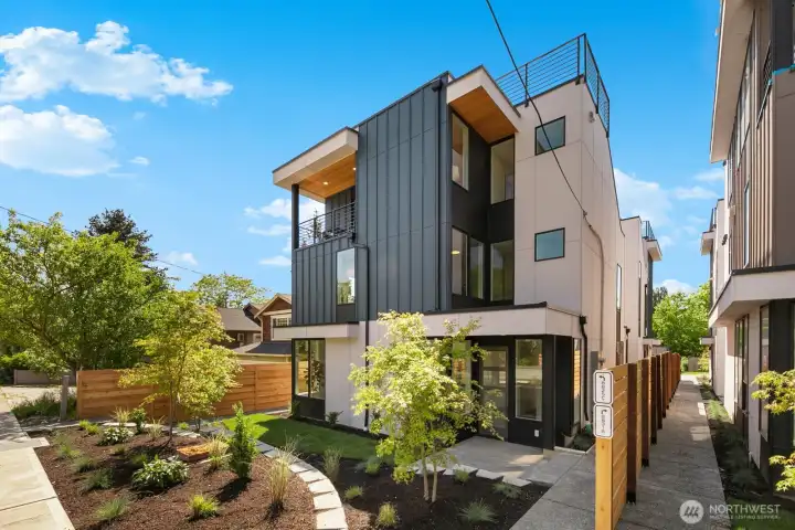 Fresh modern curb appeal in Wallingford: crisp lines, layered siding, and lush new landscaping welcome you home.