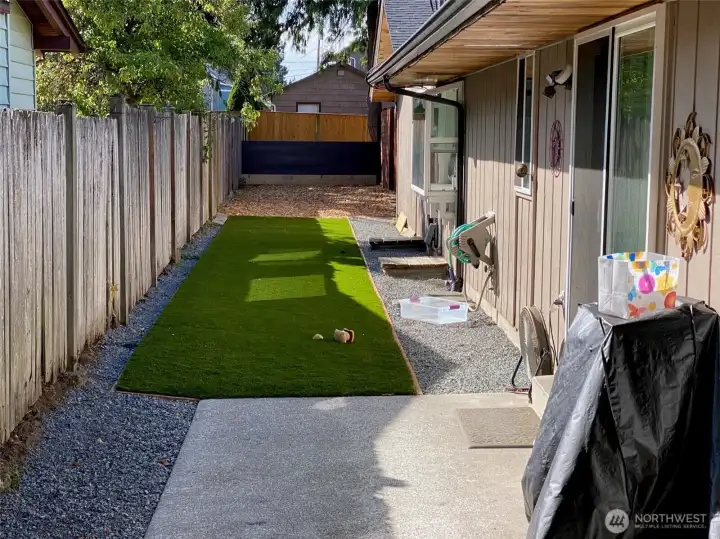 Unit B patio and yard. Artificial turf provides easy maintenance-plus pet friendly!
