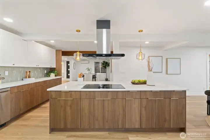 The spacious kitchen features a sunlit breakfast nook with sliding doors leading to the deck