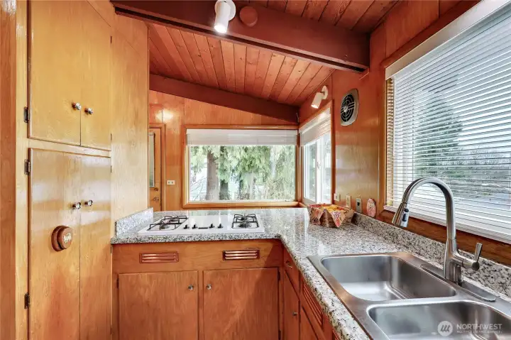 Counter stove top conveniently located near the sink.
