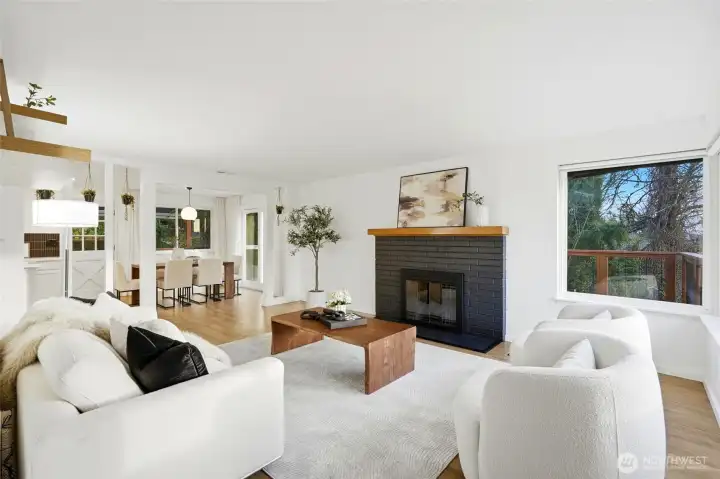 Bright living room with large windows, fireplace, and modern staging in this Kent home for sale.