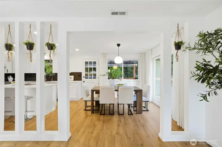 Formal dining area with hardwood floors and bright natural light, perfect for gatherings.