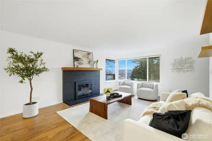 Spacious living room with fireplace and oversized windows overlooking the neighborhood.