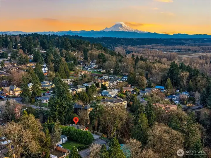 Scenic aerial view of Kent with mountain backdrop and surrounding neighborhoods.