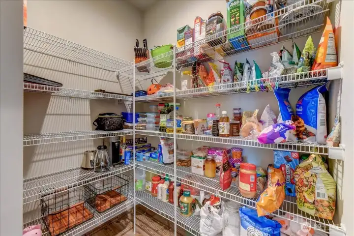 A dreamy walk-in pantry! So much space for food and small kitchen appliances.
