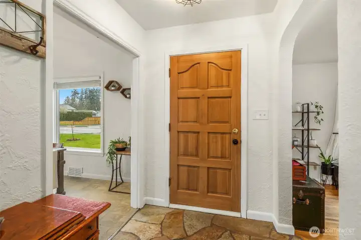 Enter onto stone detailing, arched doorways and flowing hardwoods.