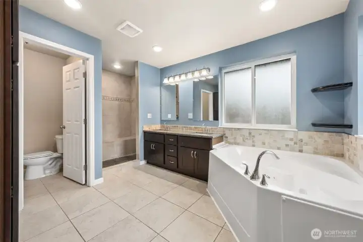 Primary bathroom with jetted tub and heated floors