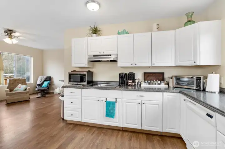 Smartly created eat-in kitchen opens to living and office spaces