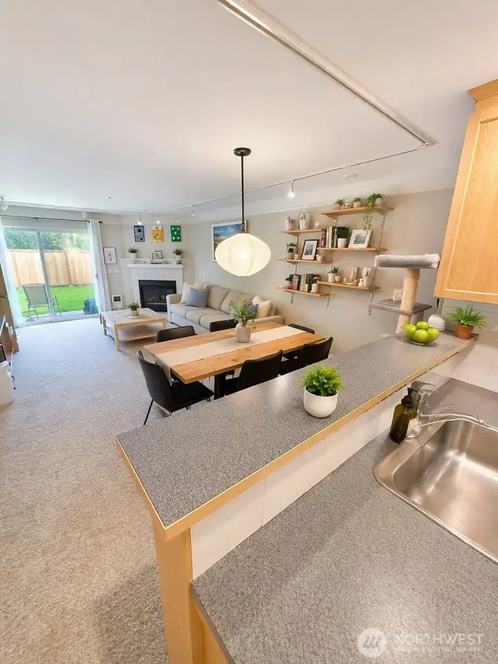 Kitchen space looking into living room.  Photo has been enhanced to better showcase the space