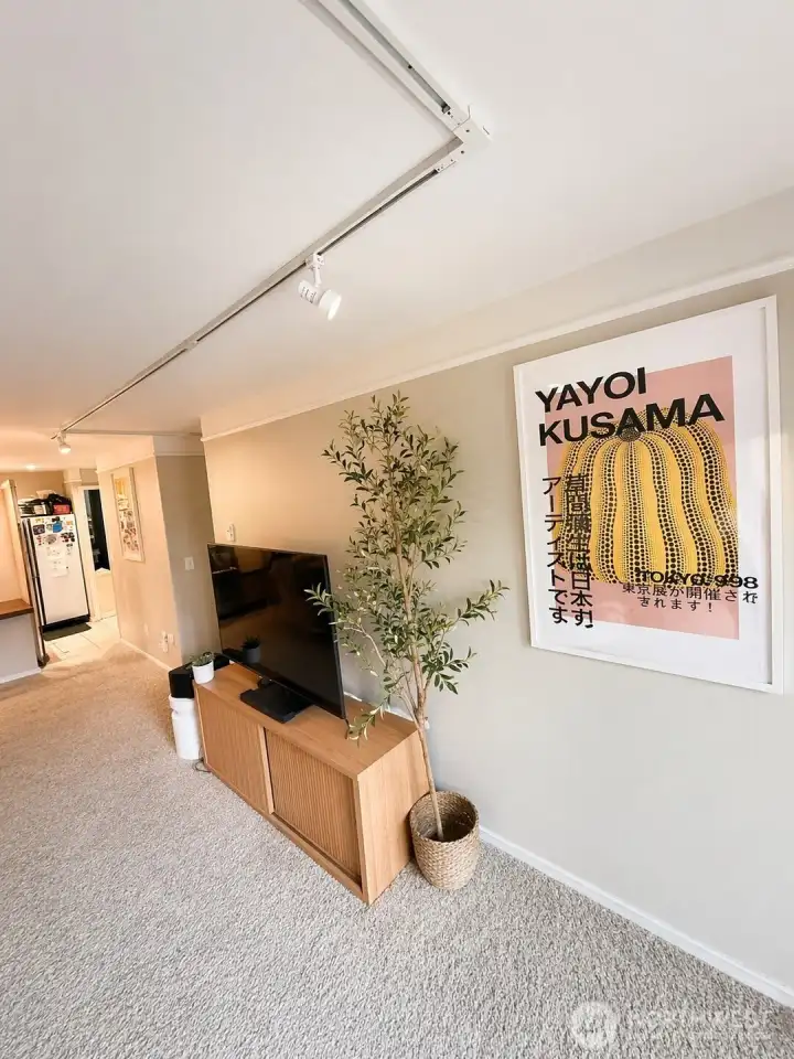 Looking back into living room towards kitchen.  Photo has been enhanced to better showcase the space.