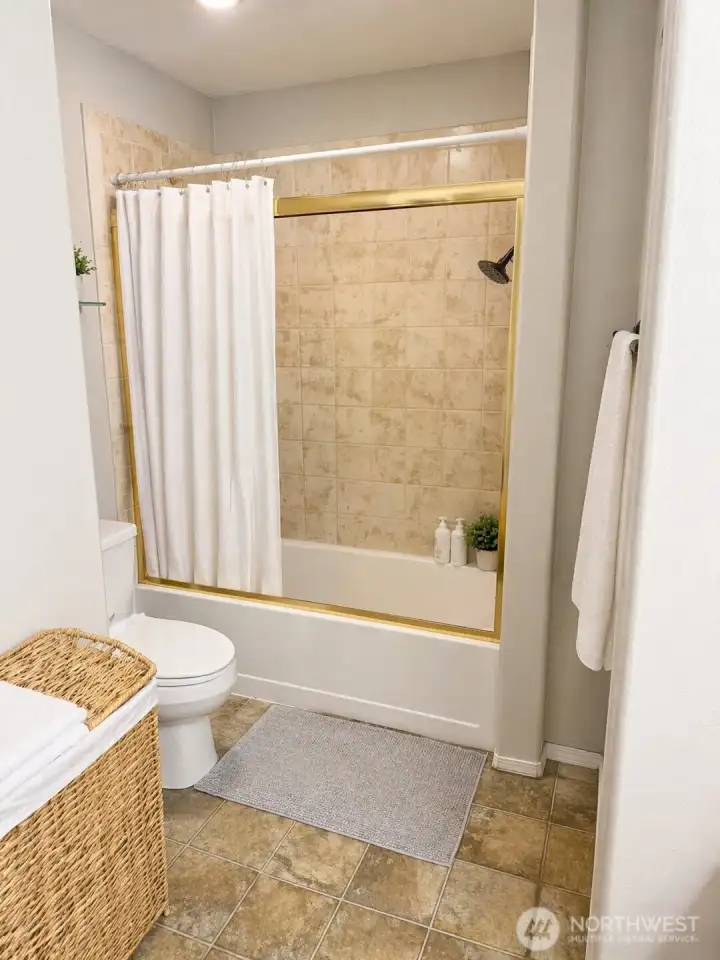 Full bathroom.  Photo has been enhanced to better showcase the space.