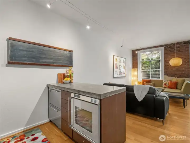 Refrigerator drawers and oven tuck nicely below this custom-made concrete countertop!