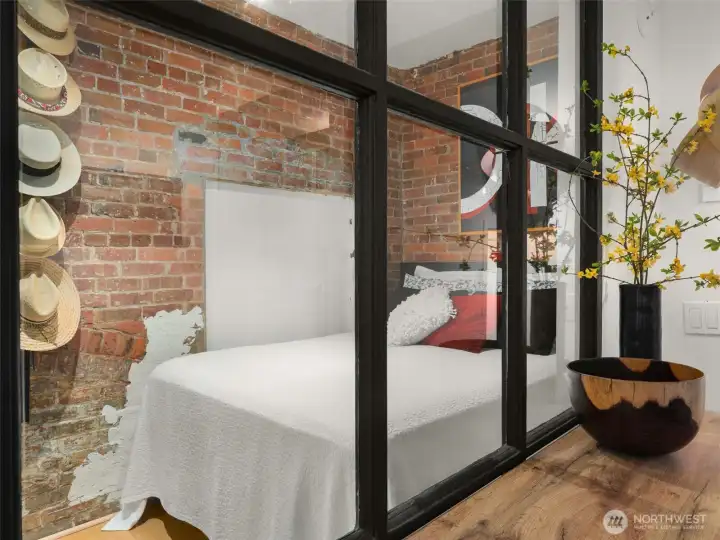 Peeking into the sleeping quarters- division of space was created by adding a wall and using a reclaimed window from the Sanitary Market at Pike Place, circa early 1900's. Window adds a bit of lightness, as well as additional local history.