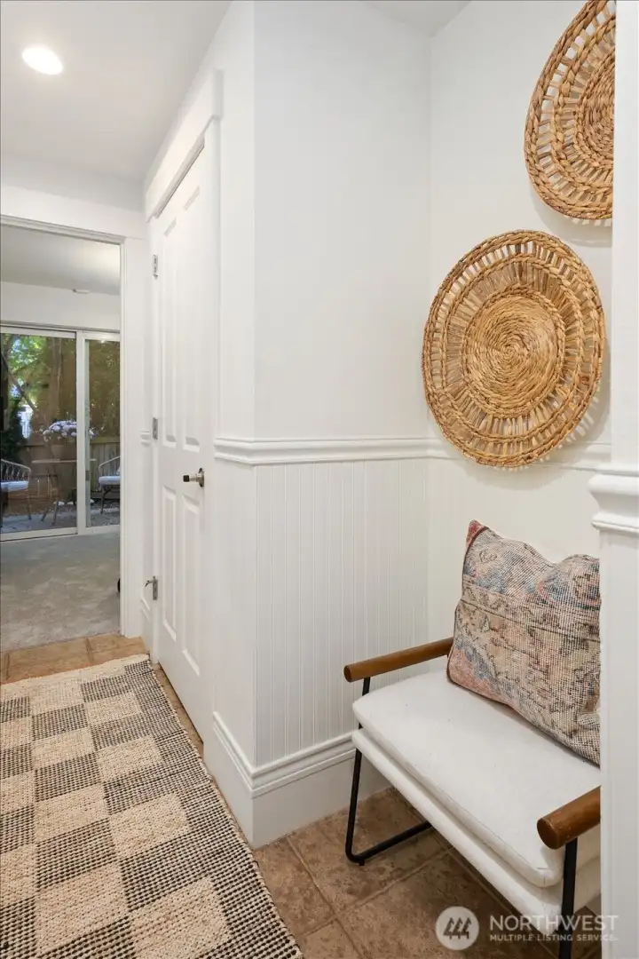 Wainscoting, warm textures, and clean lines create an inviting first impression on the lower level.