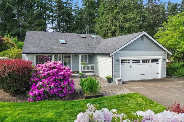 Lovely curb appeal with mature and thoughtfully designed landscaping that blooms all season long!