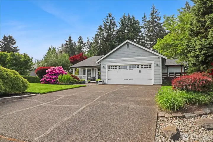 Attached 2 car garage and large concrete driveway provide ample primary parking.