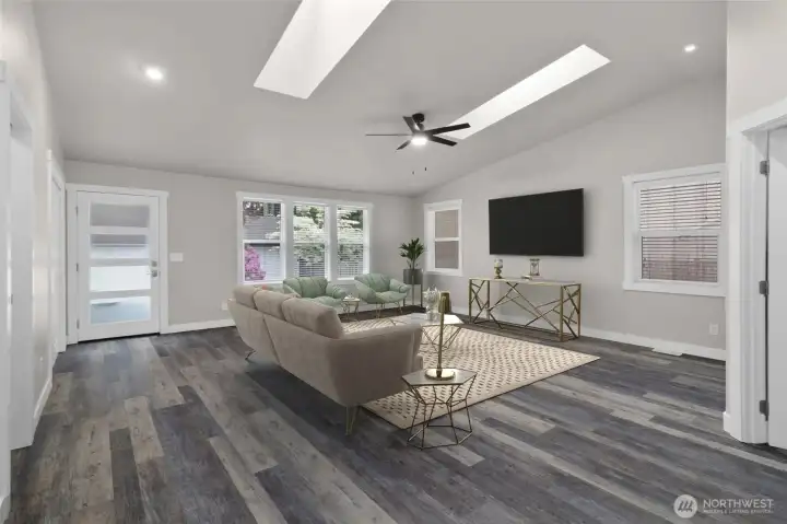 Right off the kitchen is a large, open great room with ample windows and skylights making the room bright and cheery, while the high quality LVP flooring will hold up to all life throws its way.  *Room is virtually staged.
