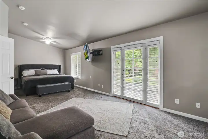 The large primary bedroom offers ample space and its own access to the expansive deck and back yard.