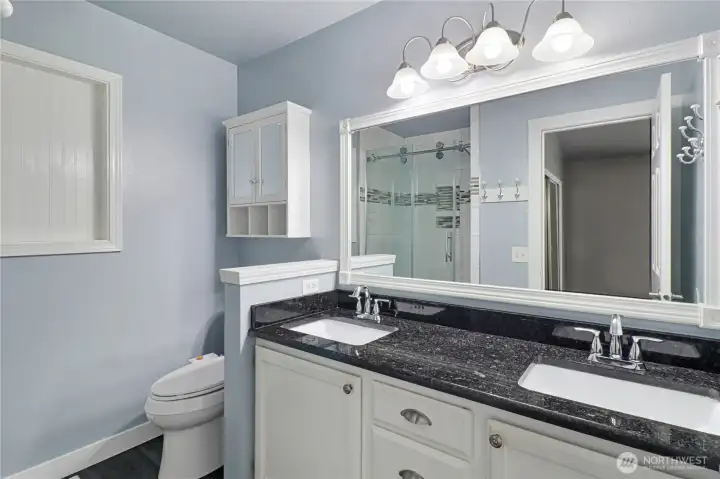 Double vanity and shower complete this 3/4 bath off the primary bedroom