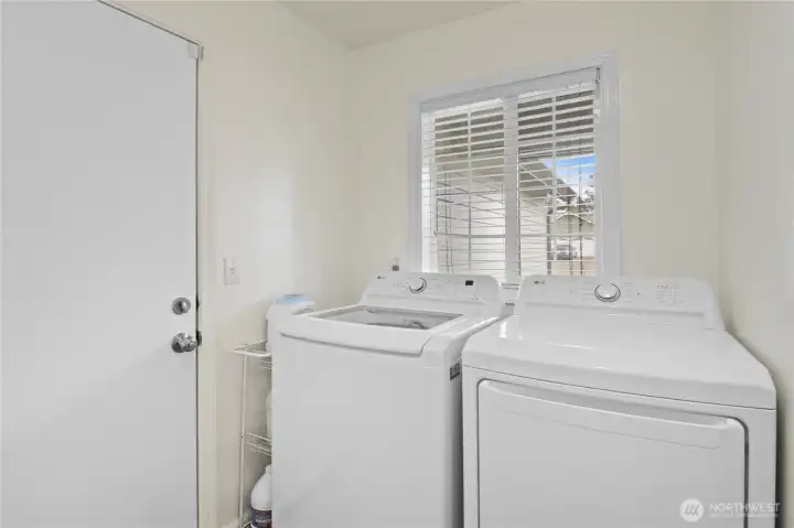 Laundry/mudroom off kitchen with easy access to garage and central location to home is convenient.