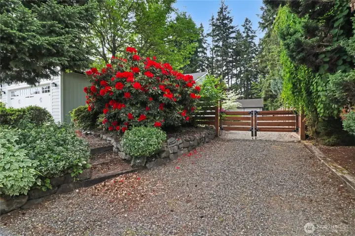 Large additional driveway with private gate leads to back yard and detached garage, with ample additional off street parking.