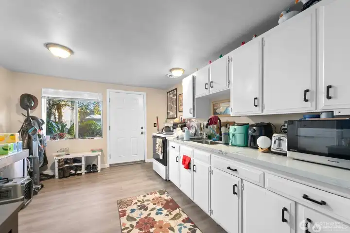 Unit 3 - Refreshed kitchen with LVP flooring, painted cabinets, quartz counters, and newer hardware. Unit 3 - Refreshed kitchen with LVP flooring, painted cabinets, quartz counters, and newer hardware.