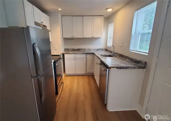 Unit 4 kitchen with newer appliances, cabinets, countertop, and LVP flooring. (Previous leasing photos). Unit 4 kitchen with newer appliances, cabinets, countertop, and LVP flooring. (Previous leasing photos).
