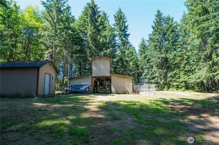 4 stall barn with tack room that has electric and water, chicken coop, shed with flooring and electric
