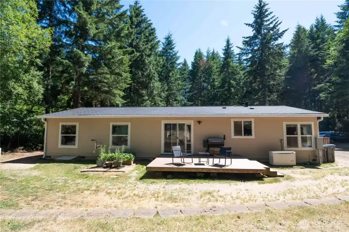View of the back of the home with porch and sliding door