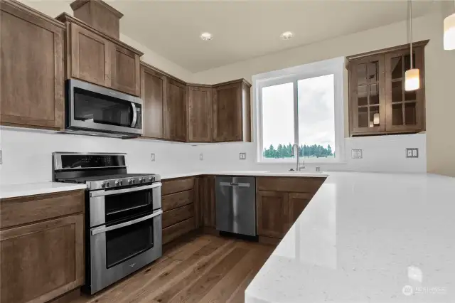 SS appliances, quartz counter tops, Canyon Creek Maple cabinets thoughout. Photo for illustration only, not actual